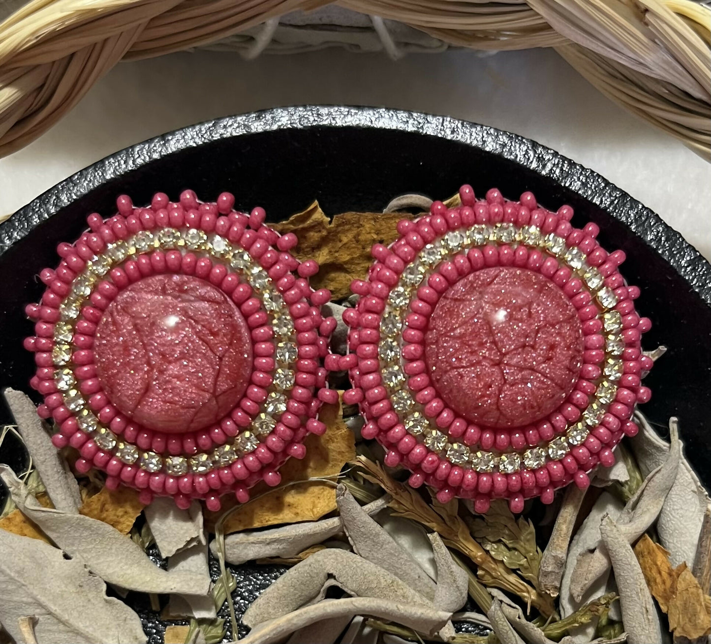 Pink earrings on fingernail posts